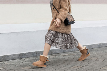 fur coat artificial fur, long dress leopard print, ugg boots, model girl posing walks on the street...