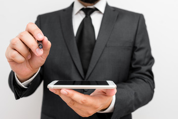 Male human wear formal work suit hold smart hi tech smartphone use one hand