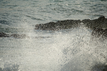 beach waves break against the breakwater