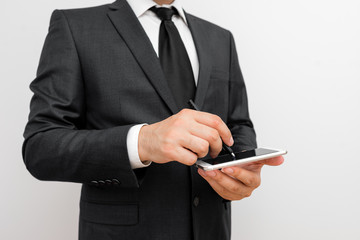 Male human wear formal work suit hold smart hi tech smartphone use one hand