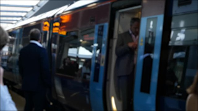 Man standing for a train blurred and delayed waiting for train to depart