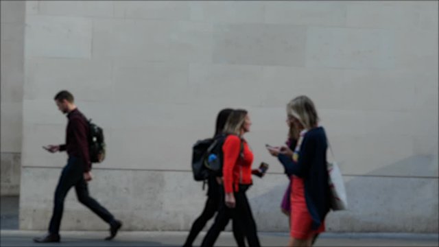 Wide shot of people walking horizontally across the path, mixed people diverse