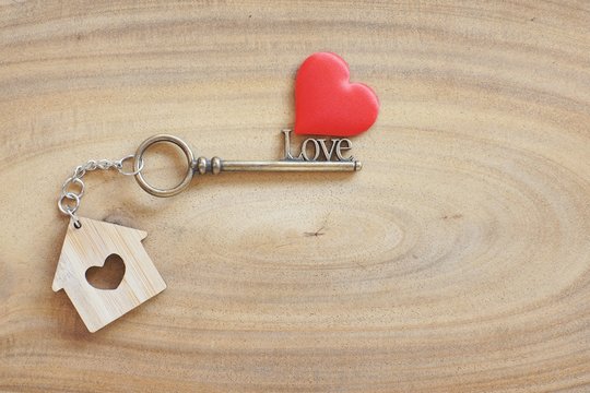 House Keyring And Love Shape Key On Vintage Wooden Table. Decorated With Mini Heart As Sweet Gift For Lover Or Family Member. Home Sweet Home Concept.