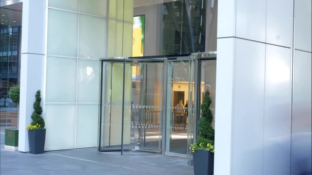 Business timelapse of a building door spinning around revolving people through London