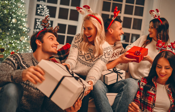 Group Of Friends Celebrating Christmas At Home