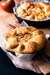 Food concept fresh baked golden Homemade Organic Apple Galette pie buttery crust in iron skillet pan with copy space