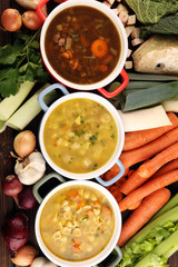 Set of soups from worldwide cuisines, healthy food. Broth with noodles, beef soup and broth with marrow dumplings. All soups with healthy vegetables on table