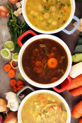 Set of soups from worldwide cuisines, healthy food. Broth with noodles, beef soup and broth with marrow dumplings. All soups with healthy vegetables on table