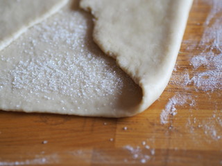 shortcrust pastry with flour and rolling pin on a table