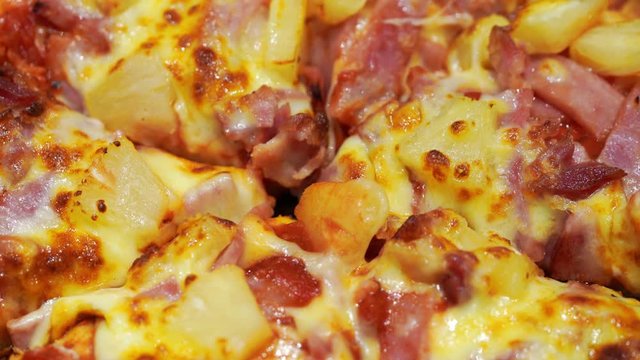 Close up Hawaiian Pizza spinning.