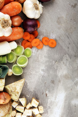 Fototapeta na wymiar Vegetables cooking ingredients for tasty vegetarian soups. Carrot , onion , garlic , parsley on rustic background