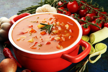 Minestrone soup in a bowl on a light table, top view. Italian soup with pasta and seasonal vegetables. Delicious vegetarian food concept.