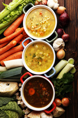 Set of soups from worldwide cuisines, healthy food. Broth with noodles, beef soup and broth with marrow dumplings. All soups with healthy vegetables on table