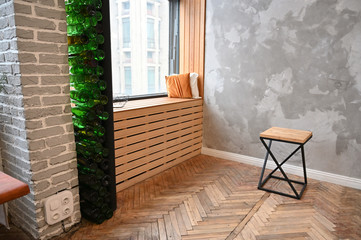 The concept of designing a room in a natural style. Photo of a beautifully furnished interior with a chair and decorative elements in a rustic image of a cozy house.