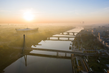 Drone Shot. Cityscape with river and bridges in the morning in the fog. Warsaw. Poland. Aerial view...