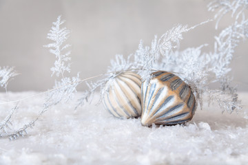 Obraz na płótnie Canvas Glass ornaments with silver branch on artificial snow
