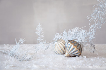 Fototapeta na wymiar Glass ornaments with silver branch on artificial snow