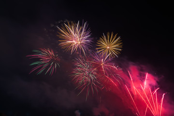 Abstract and brightly colorful firework in the celebration and anniversary festival.Merry Christmas and New year party light over night sky.