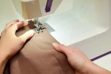 Obraz na płótnie Canvas stitching fabric on a sewing machine