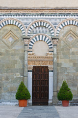 Fototapeta na wymiar Pistoia Tuscany Italy San Bartolomeo church old entrance door with columns and marble arches