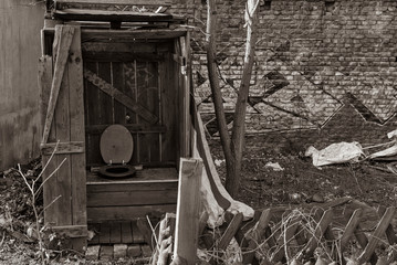 a dilapidated latrine, deserted places, crumbling outside toilet, black and white