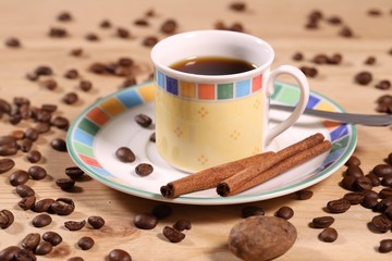 cup of natural coffee garnished with cinnamon and nutmeg
