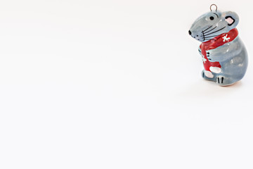 Ceramic figurine of a Christmas rat on a white background. Symbol of the new year 2020.