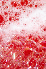 Close Up of Bath Water Bubbles Foam For Background In Red Pink