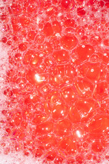 Close Up of Bath Water Bubbles Foam For Background In Red Pink
