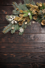 Fototapeta na wymiar fir branches with Christmas decor on old dark wooden background