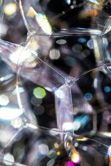 Close Up of Bath Water Bubbles Foam For Background In Black Rainbows