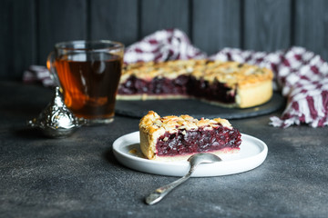 Delicious Homemade Cherry Pie with a Flaky Crust on dark background