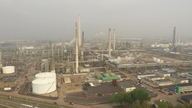 Aerial view of smokestacks and pipelines of massive petrochemical oil refinery of the multinational Shell corporation in the Netherlands