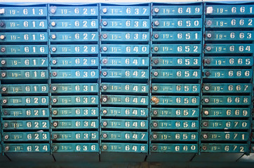 Old blue post office boxes. Aged mailbox cells with numbers. Ukraine.