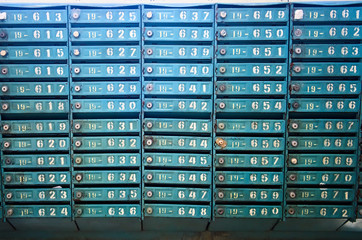 Old blue post office boxes. Aged mailbox cells with numbers. Ukraine.