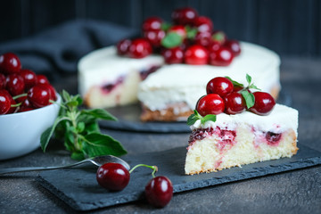 Delicious Homemade Cherry Pie with a fresh berries on dark background.