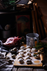 Pelmeni on wooden board.style rustic.