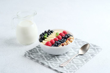 Oatmeal with berries and fruits on a light background. Healthy breakfast.