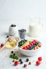 Oatmeal with berries and fruits on a light background. Healthy breakfast.