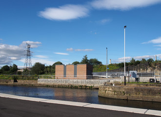 Fototapeta na wymiar the lock gates between the river aire and the canal at stourton leeds at the site of a proposed new brownfield inland dock development