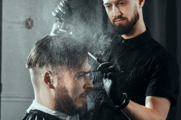 YOUNG HANDSOME MAN IN BARBERSHOP
