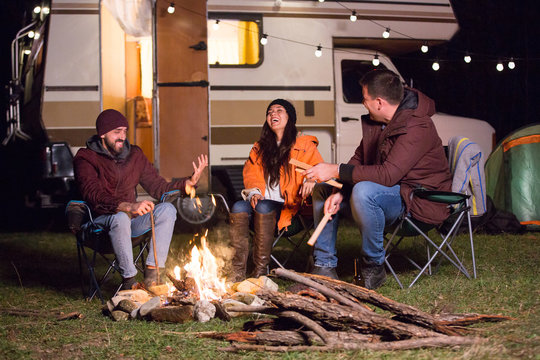 Girl Laughing Hard After Her Friends Told A Joke Around Camp Fire