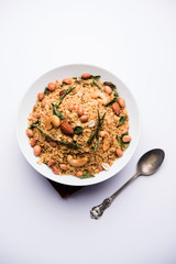 Oats Chivda / Chiwda is a healthy indian recipe with added chilli, peanuts, cashew, almond and curry leaf for flavour. Selective focus