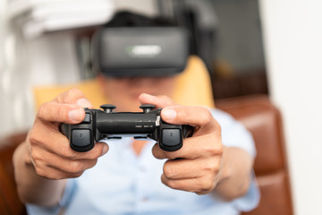 Senior businessmen relax from work in a private office to relax from business stress. By sitting watching a movie from a tablet play games on VR or read books.