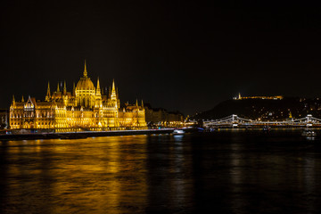 Obraz premium View on the The Hungarian Parliament Building, beside the Danube River. European travel. Night scene. Budapest. Hungarian. 