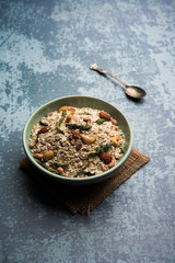 Oats Chivda / Chiwda is a healthy indian recipe with added chilli, peanuts, cashew, almond and curry leaf for flavour. Selective focus