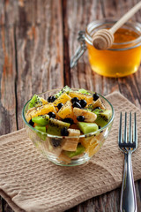 Fresh fruit salad for a healthy diet on wooden background