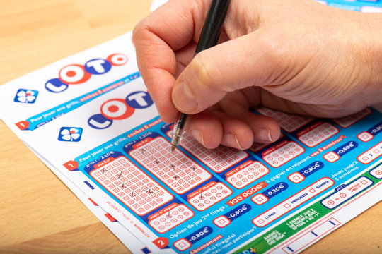 Paris, France -  November 21, 2019 : Closeup of aperson filling a lotto grid ,  from the society FDJ  (La francaise des jeux)