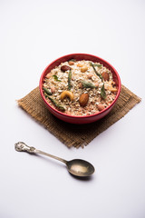 Oats Chivda / Chiwda is a healthy indian recipe with added chilli, peanuts, cashew, almond and curry leaf for flavour. Selective focus