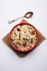 Oats Chivda / Chiwda is a healthy indian recipe with added chilli, peanuts, cashew, almond and curry leaf for flavour. Selective focus